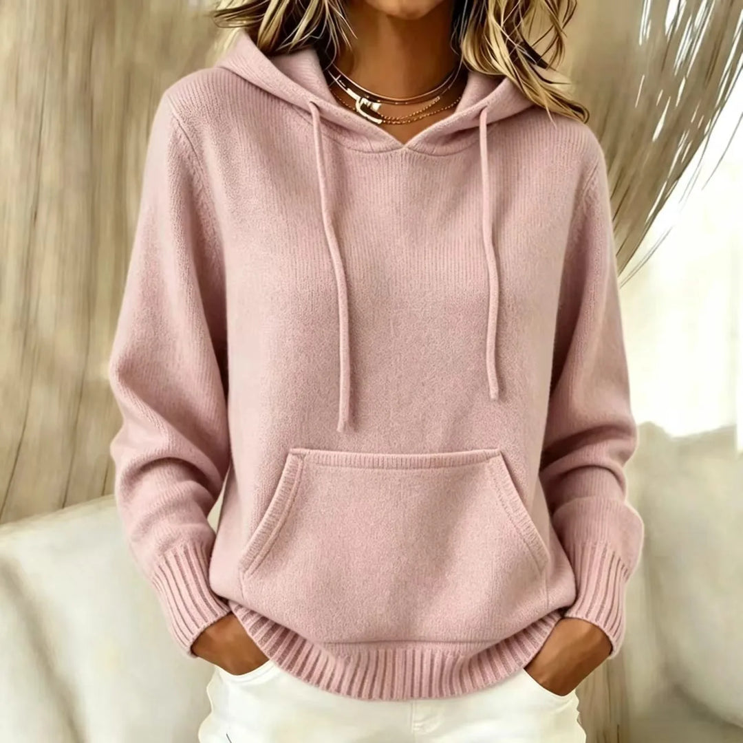 Woman wearing pink hooded knit sweater with kangaroo pocket