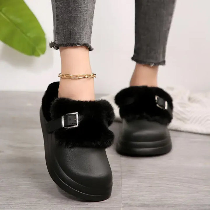 Black faux fur platform clog slipper worn on foot, back view