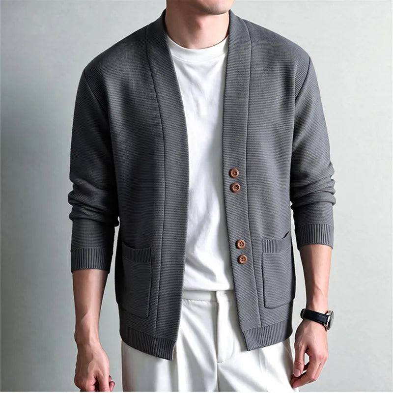 Man wearing gray knit shawl collar cardigan with wood buttons