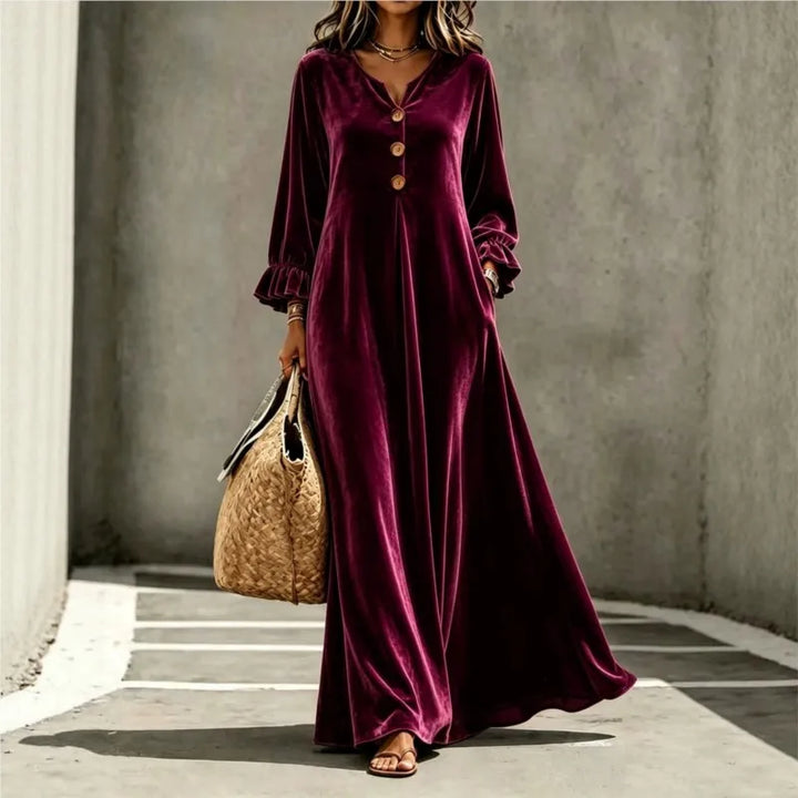 Woman wearing burgundy velvet maxi dress, front view