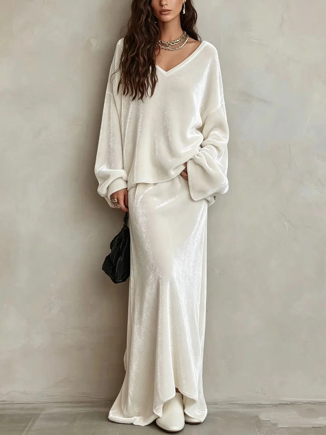 Close up of white velvet V neck pullover and maxi skirt set