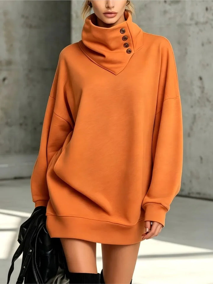 Orange sweatshirt dress with buttoned collar, close up view