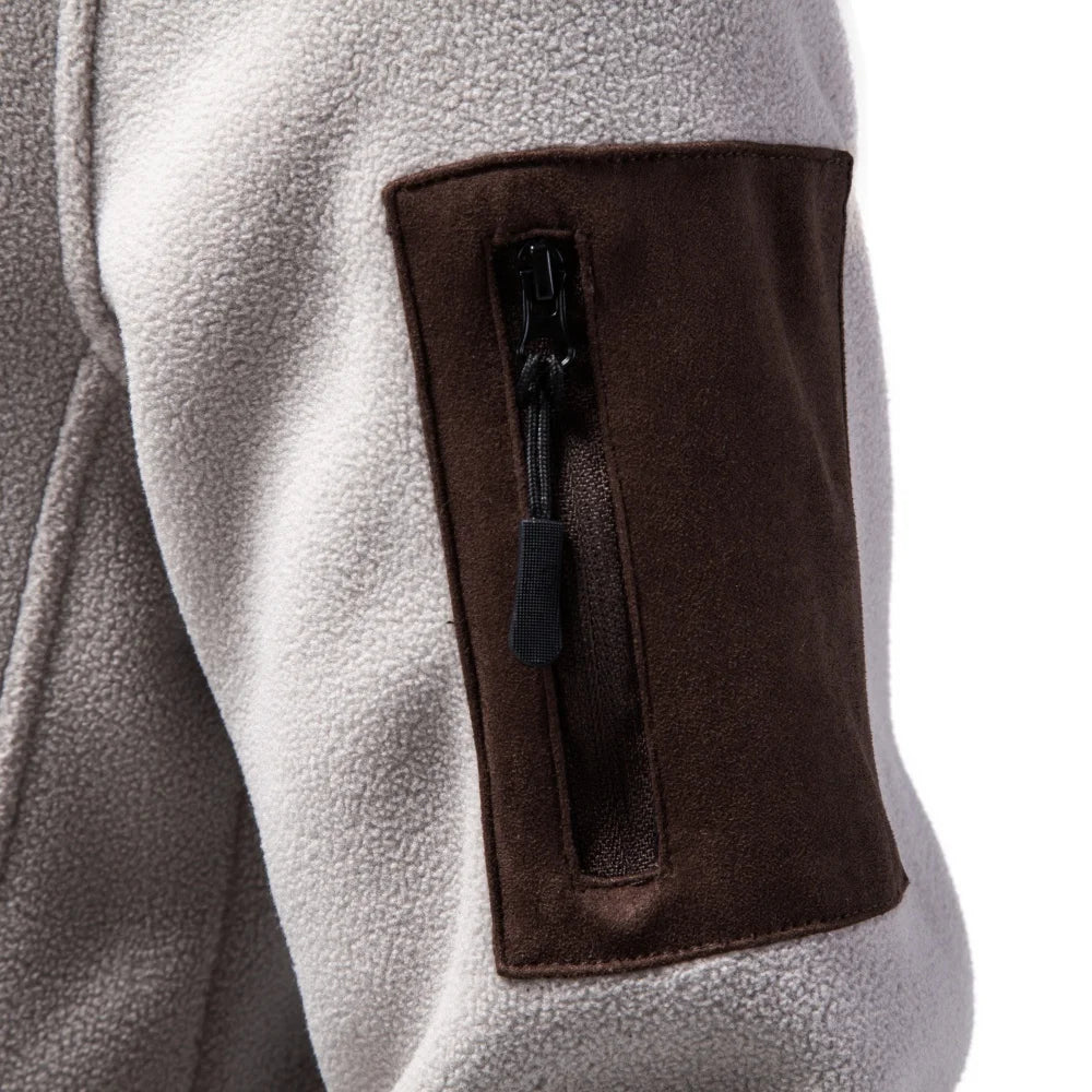 Close up of zippered sleeve pocket on apricot fleece jacket