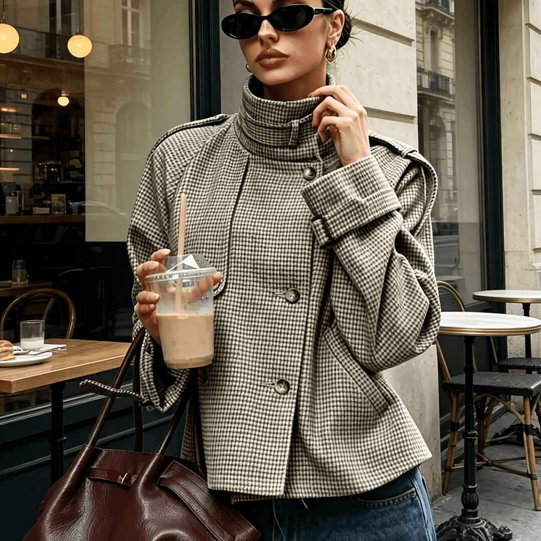 Woman wearing cropped houndstooth jacket with stand collar, front view