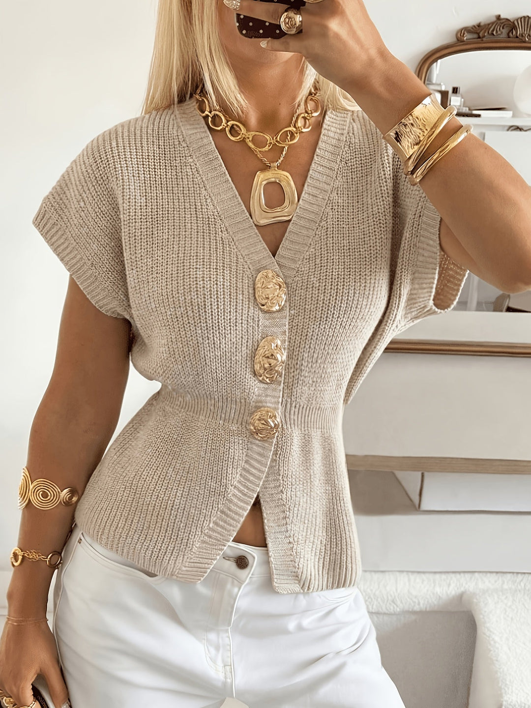 Woman wearing apricot ribbed knit button-front cardigan with gold decorative buttons