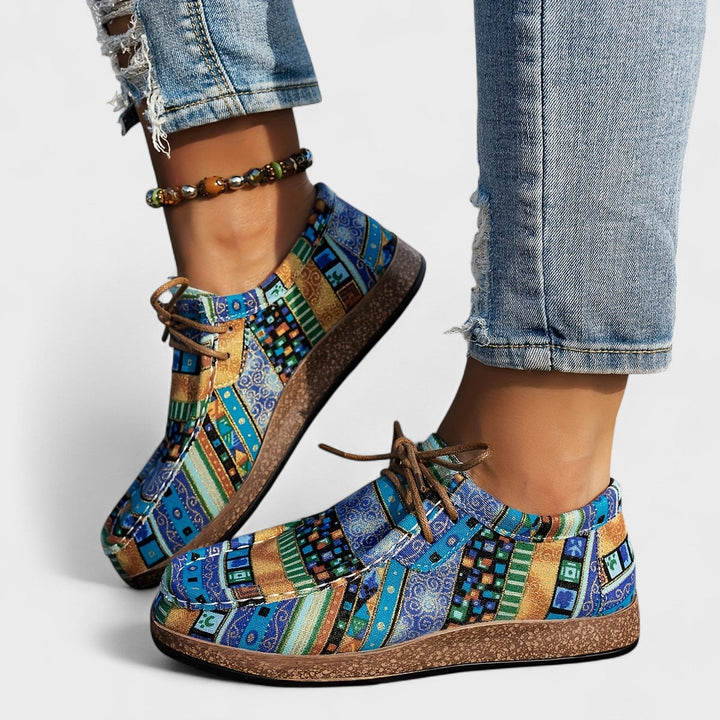 Blue patchwork print lace-up sneakers on model, side view