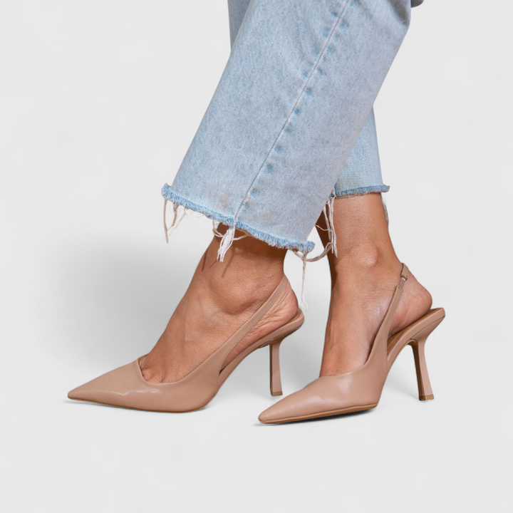 Nude slingback pointed-toe pumps on model
