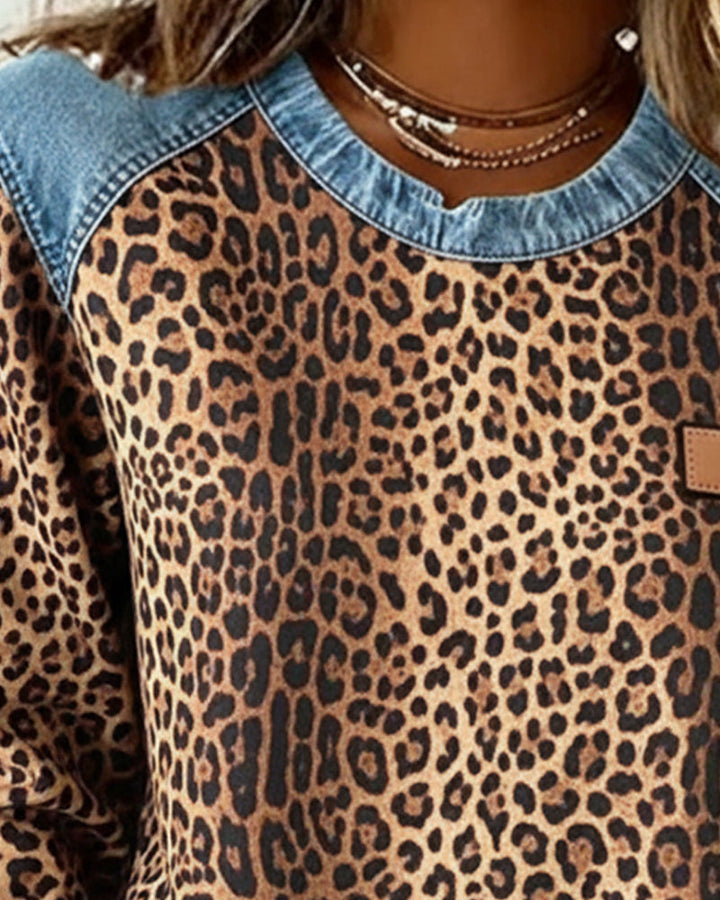 Close up of brown leopard print sweatshirt crew neckline and denim yoke