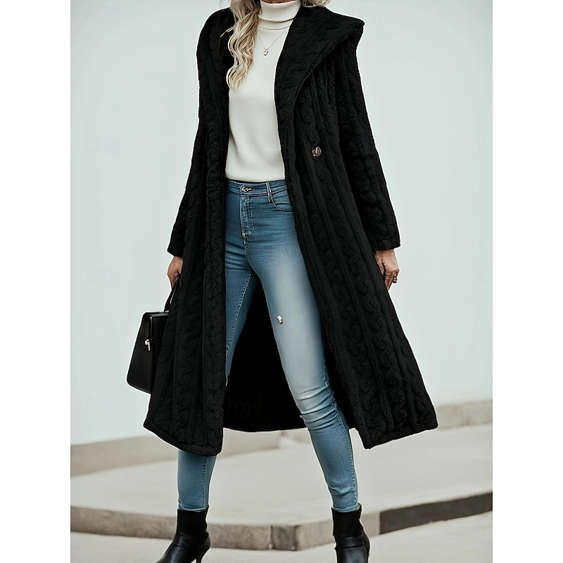 Woman wearing black textured hooded longline coat with front button closure