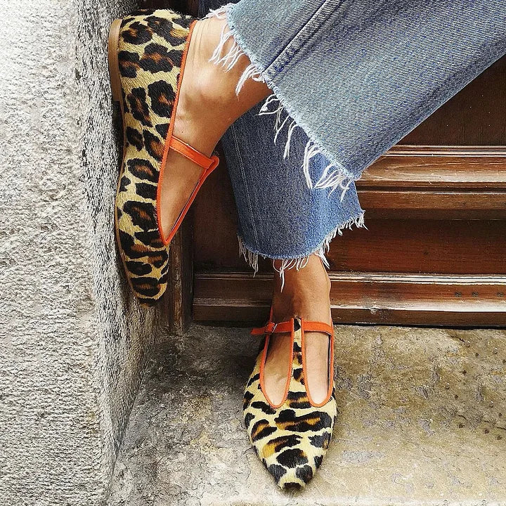Leopard print T-strap flats with orange trim worn with cropped jeans