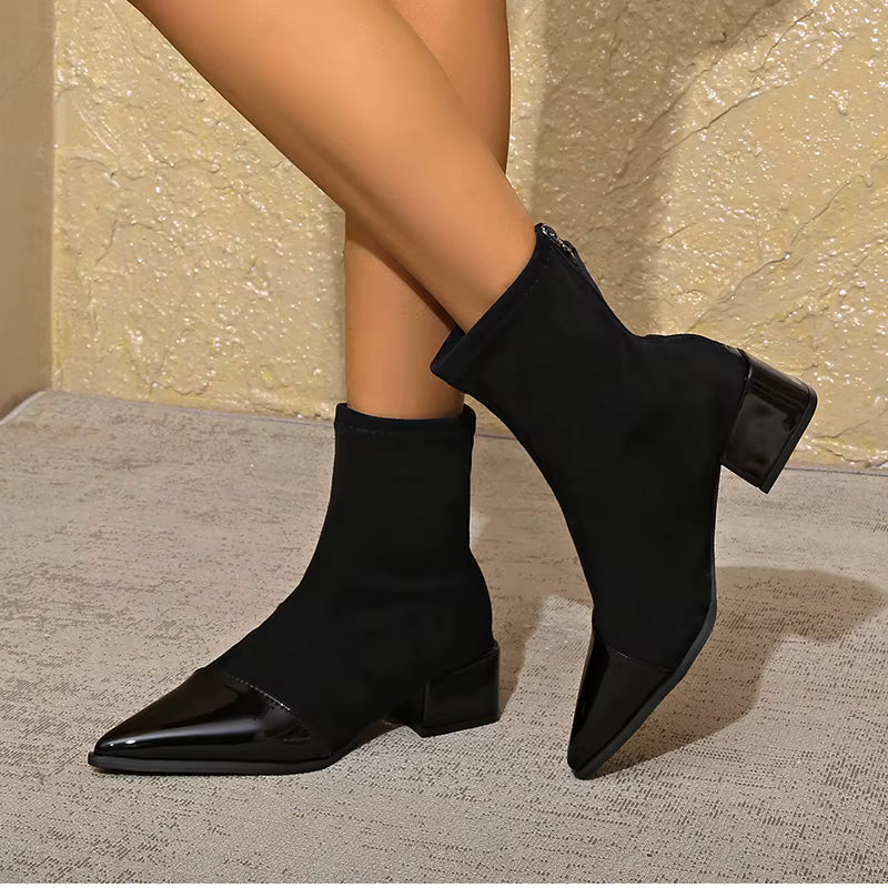 Side view of black ankle boots with glossy patent toe and block heel