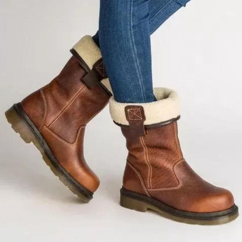 Side view of brown mid-calf boots with shearling-look fold-down cuff and buckled ankle tab