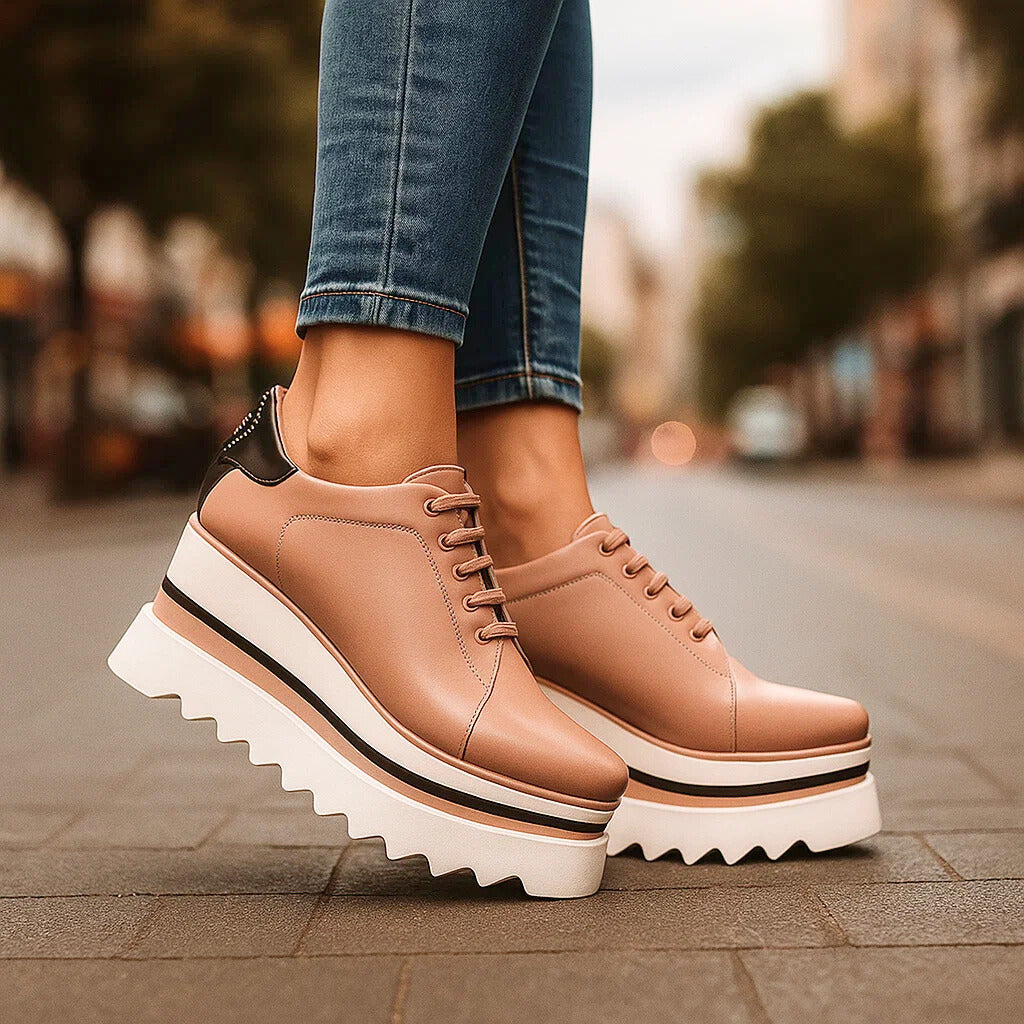 Tan platform lace-up sneakers with black heel panel detail