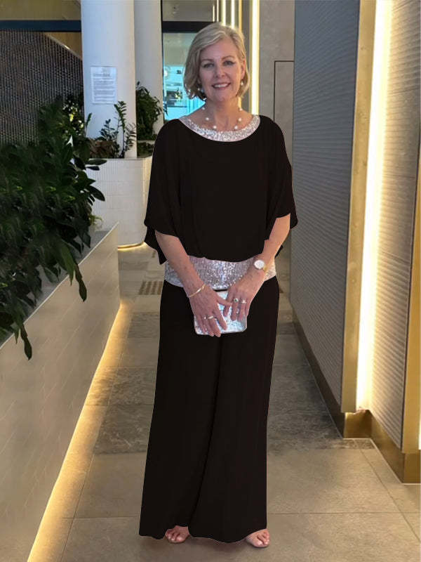 Woman wearing black wide-sleeve top and wide-leg pants set with sequin trim