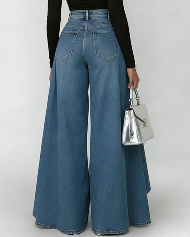 Back view of high waist wide leg blue denim jeans with sweeping flared hem