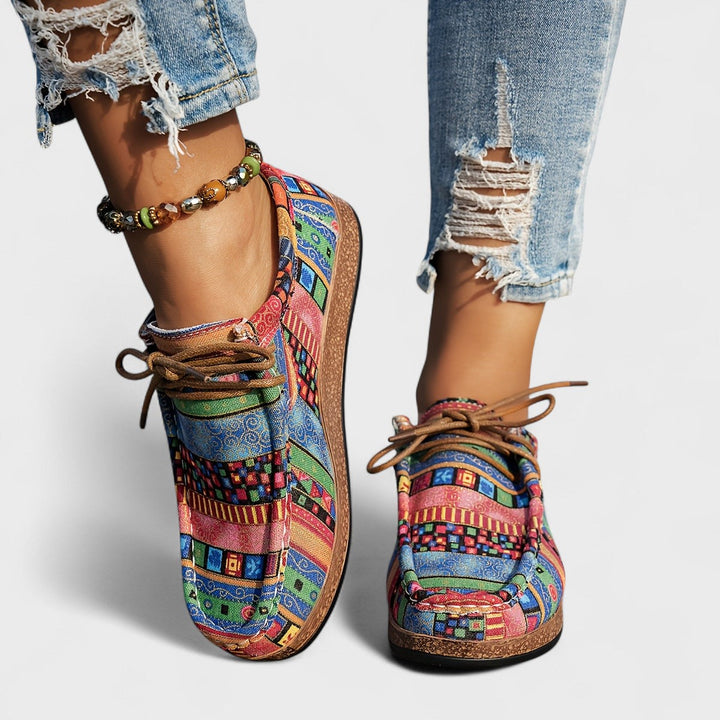 Multicolor patchwork print lace-up sneakers on model, front view