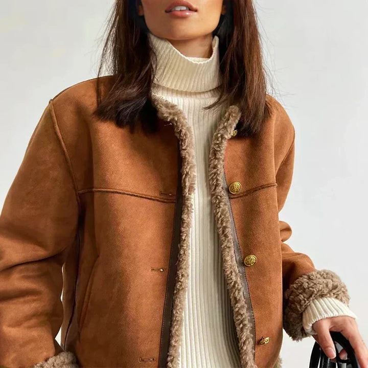 Close up of shearling jacket collar and gold snap button closures
