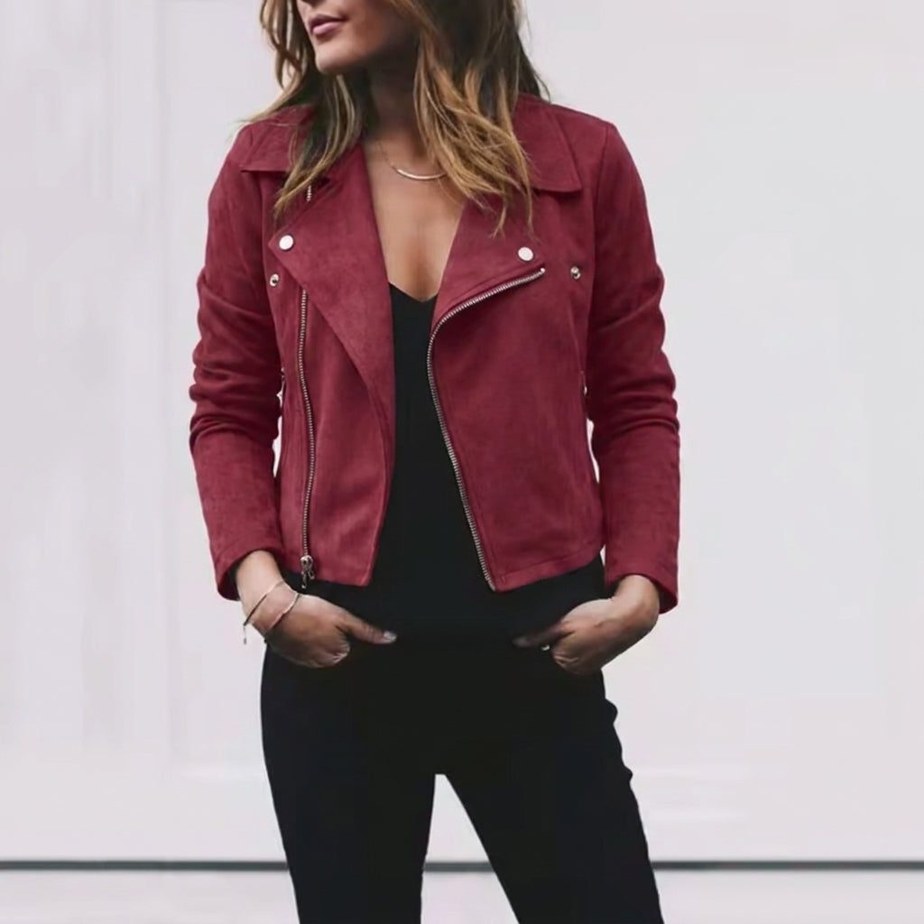 Woman wearing burgundy suede-look cropped moto jacket with asymmetrical zip