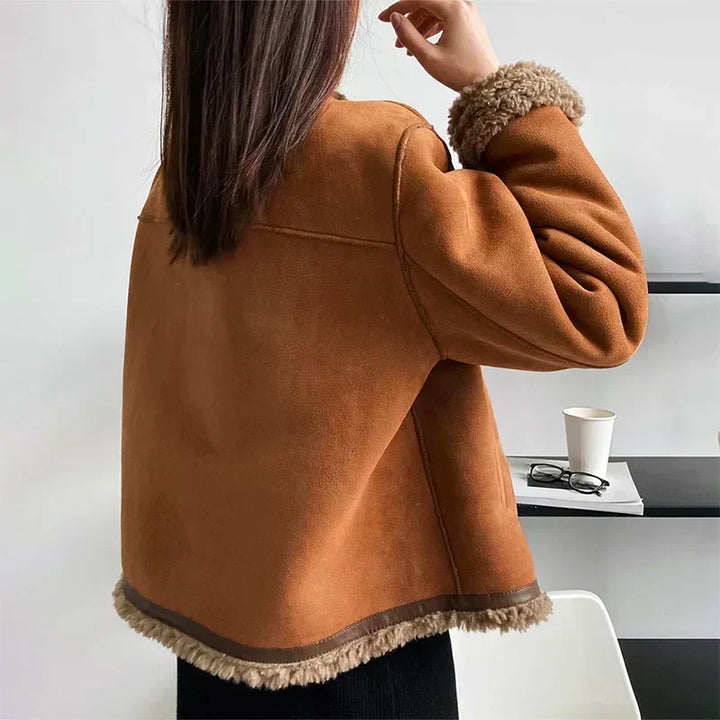 Back view of cropped shearling jacket showing fleece trim hem