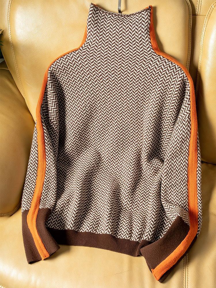Back view of herringbone knit turtleneck sweater laid flat showing orange contrast stripes and ribbed cuffs