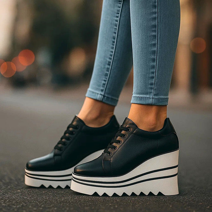 Black tiered platform sneakers with white deep tread outsole