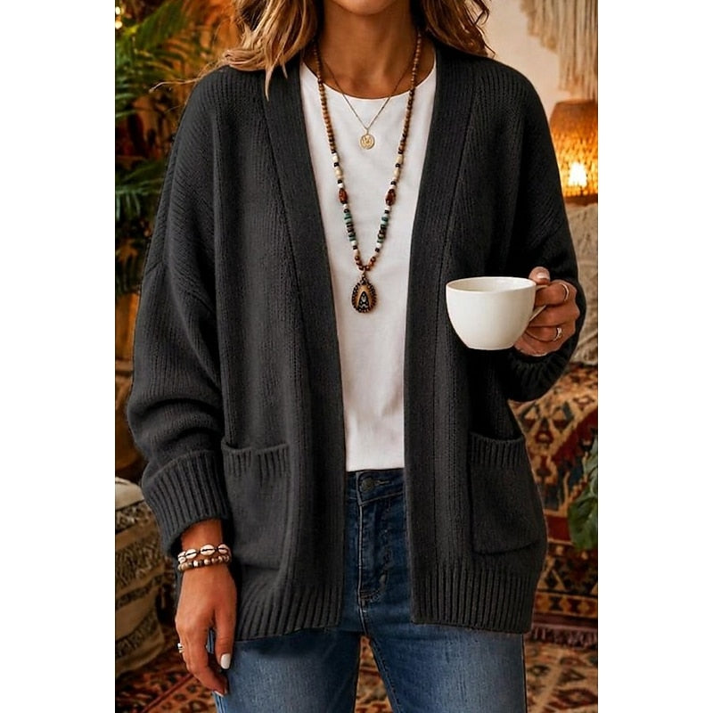 Woman wearing black open-front knit cardigan with patch pockets