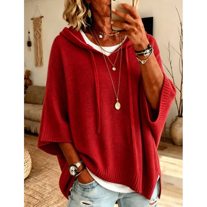 Red hooded sweater worn with layered necklaces, front view