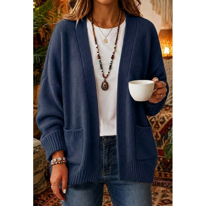 Woman wearing blue open-front knit cardigan with patch pockets