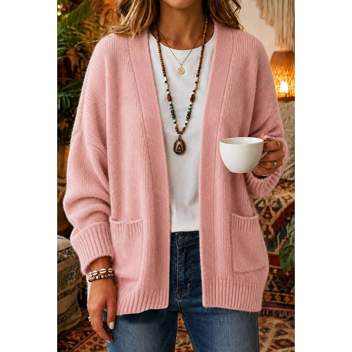 Woman wearing pink open-front knit cardigan with patch pockets