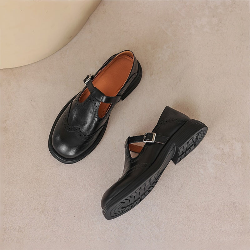 Pair of black wingtip Mary Jane flats shown from above