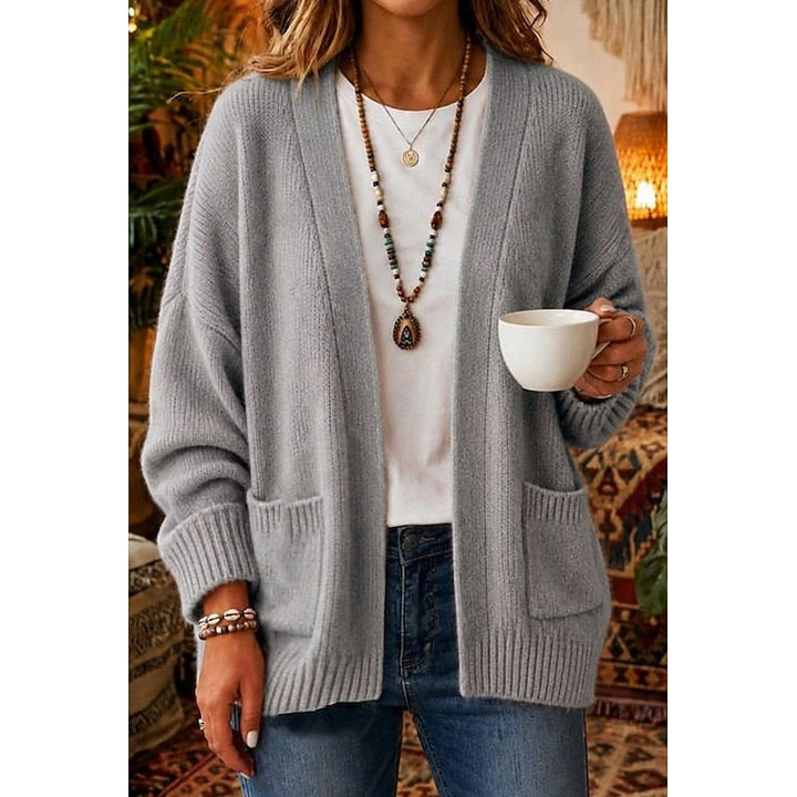 Woman wearing gray open-front knit cardigan with patch pockets