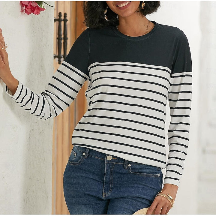 Woman wearing black and white striped long sleeve top, front view