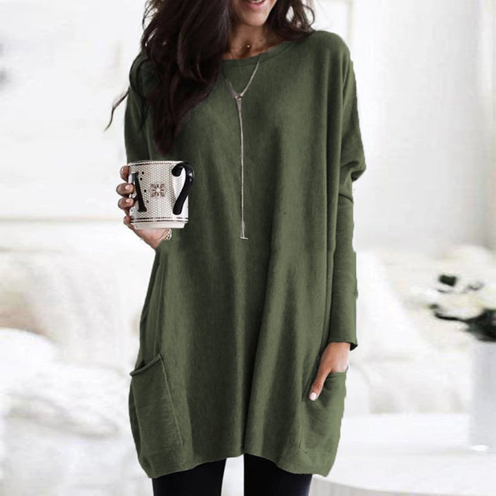 Woman wearing olive green oversized tunic top with front pocket