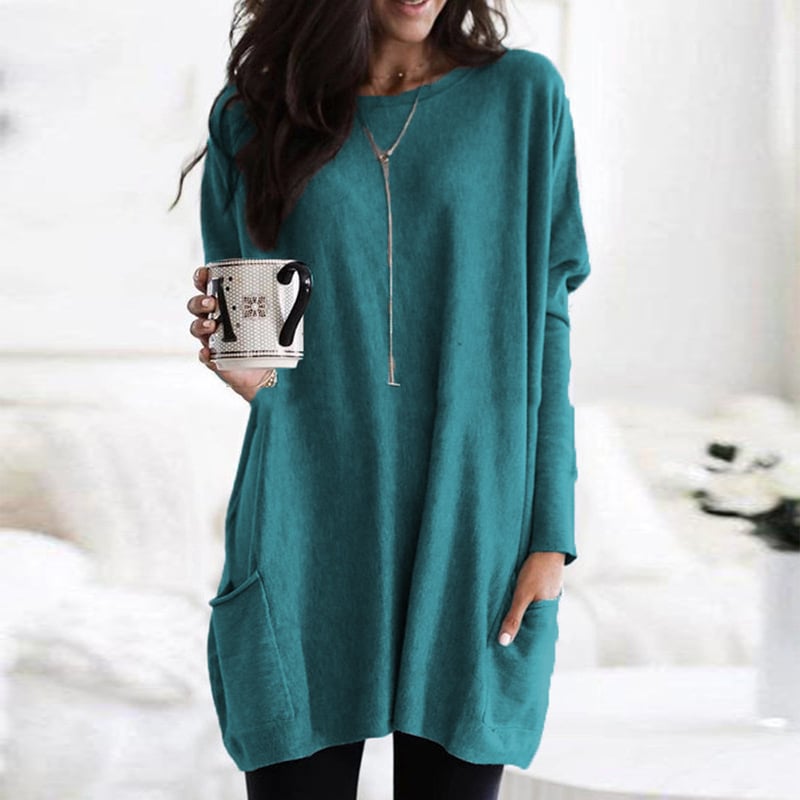 Woman wearing teal green oversized tunic top with front pocket