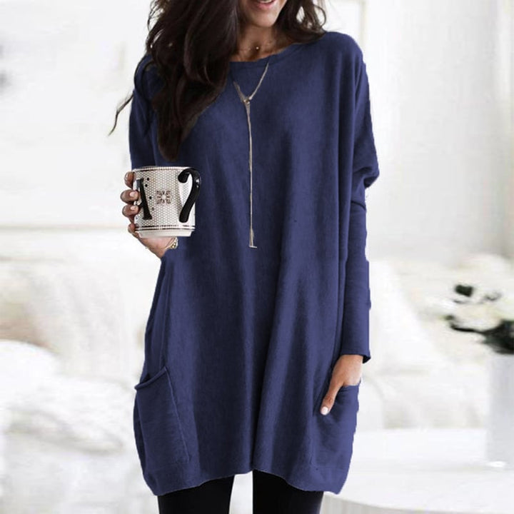 Woman wearing navy blue oversized tunic top with front pocket