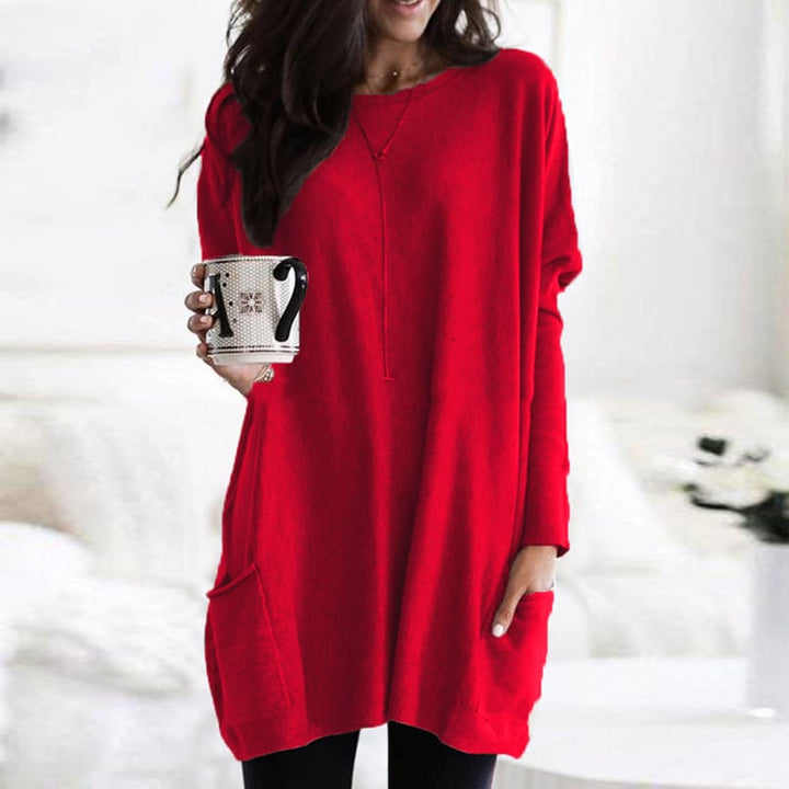 Woman wearing red oversized tunic top with front pocket