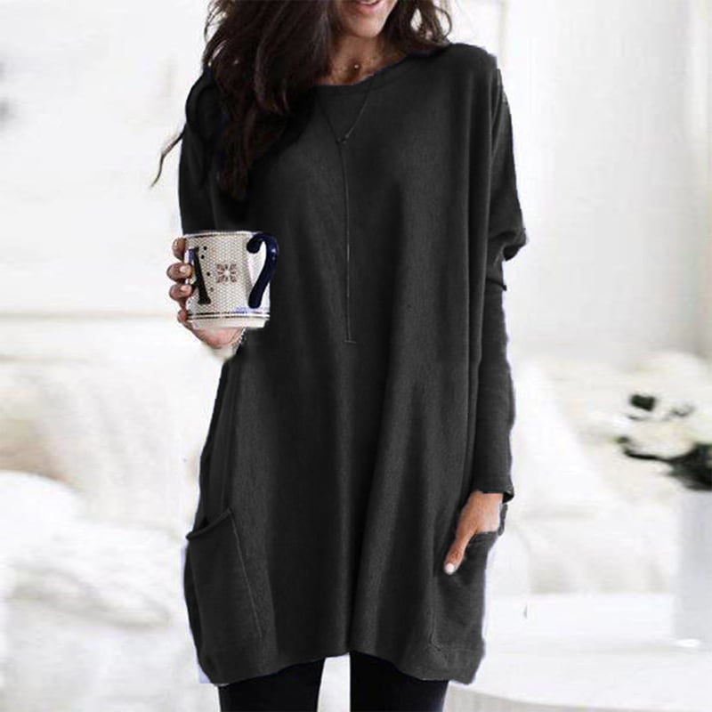 Woman wearing black oversized tunic top with front pocket