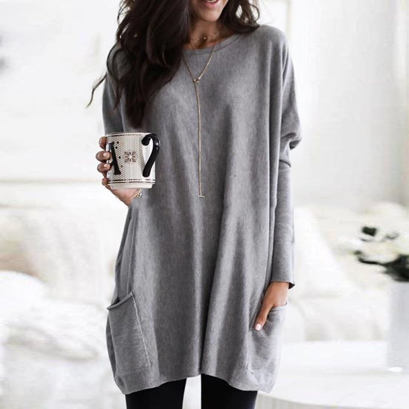Woman wearing gray oversized tunic top with front pocket