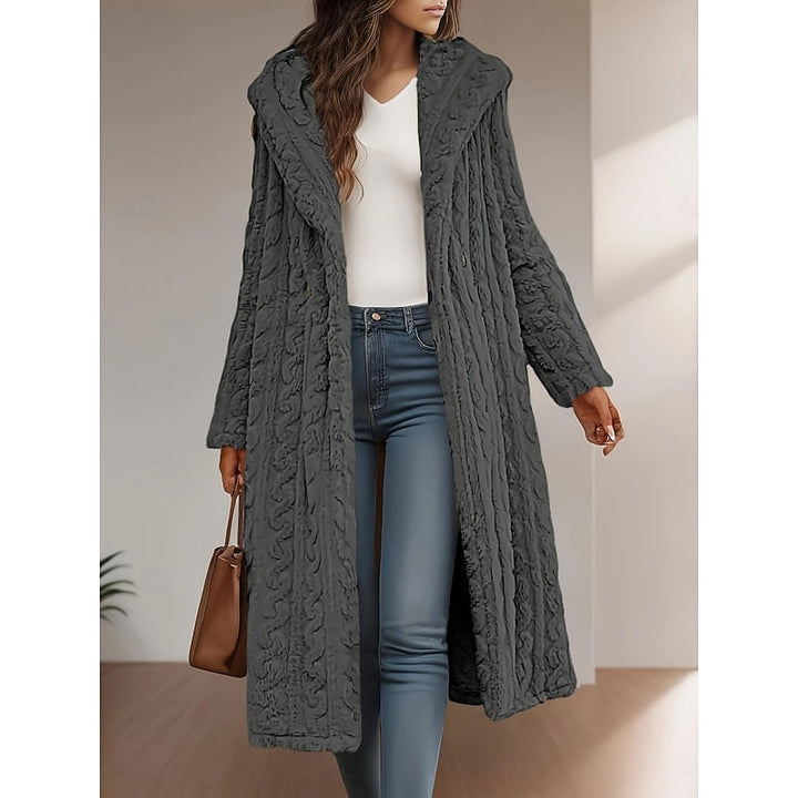 Woman wearing gray textured hooded longline coat open over white top and jeans