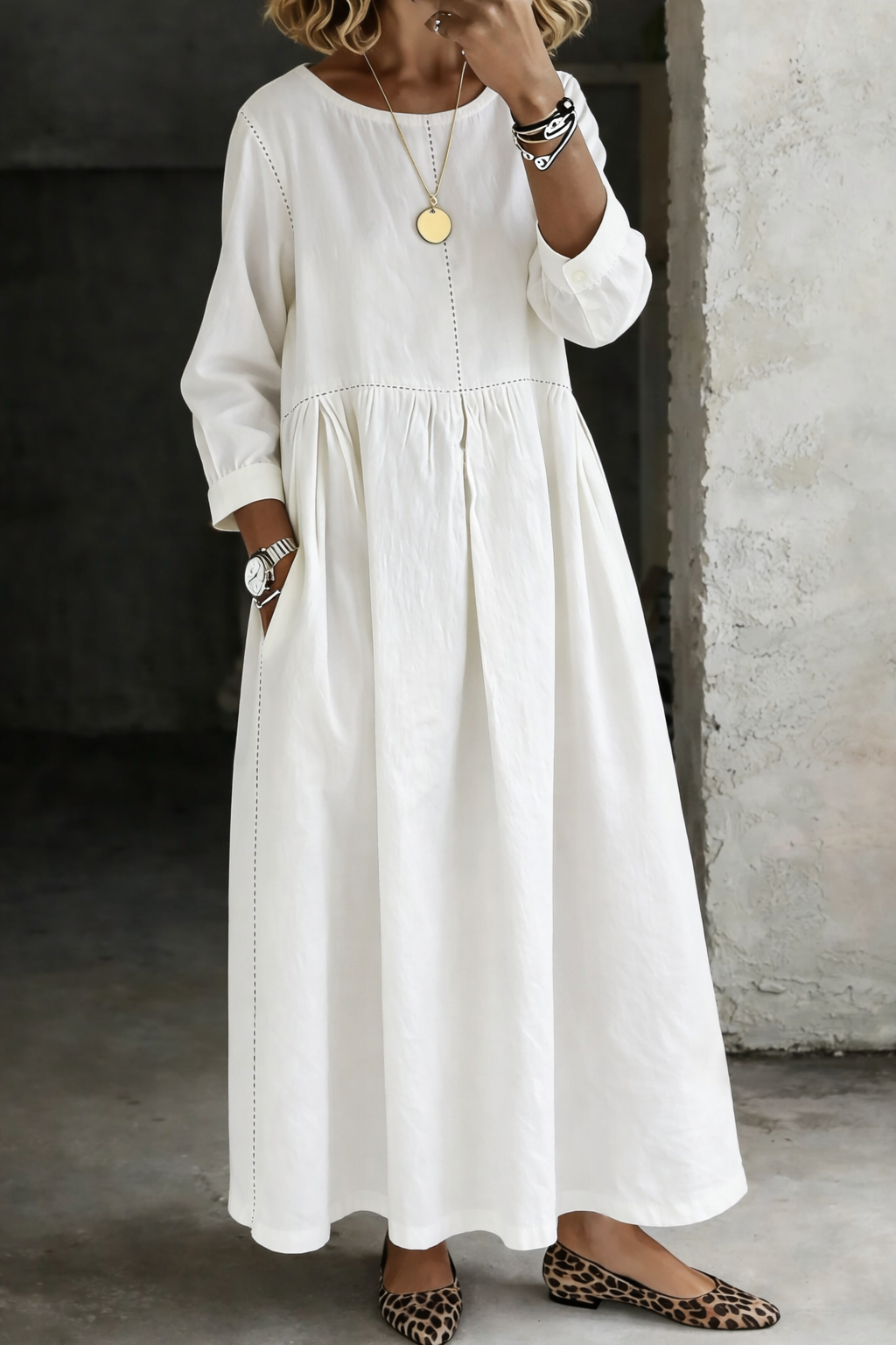 Woman wearing white maxi dress with round neck and long sleeves