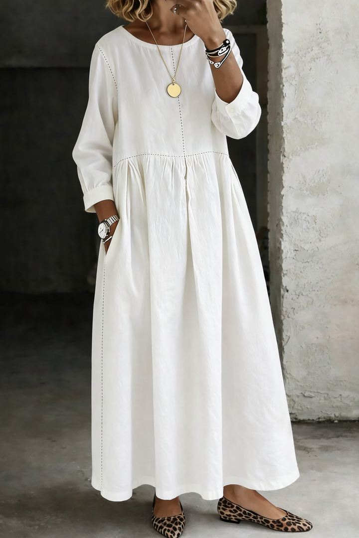 Woman wearing white maxi dress with round neck and long sleeves