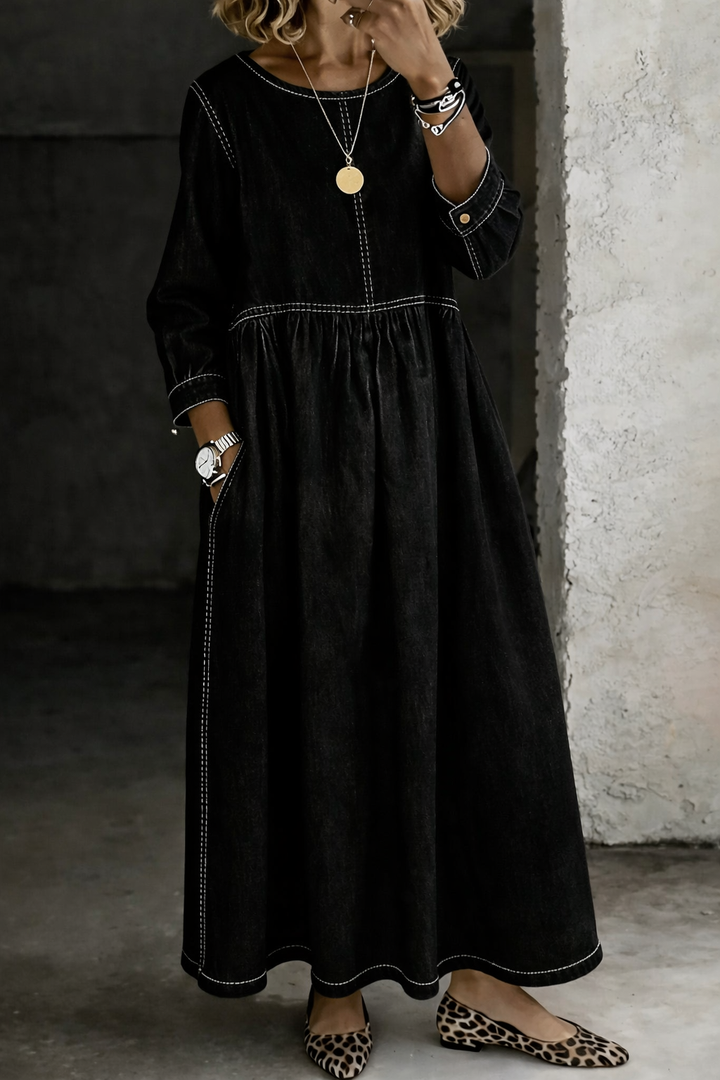 Woman wearing black denim maxi dress with round neck and long sleeves