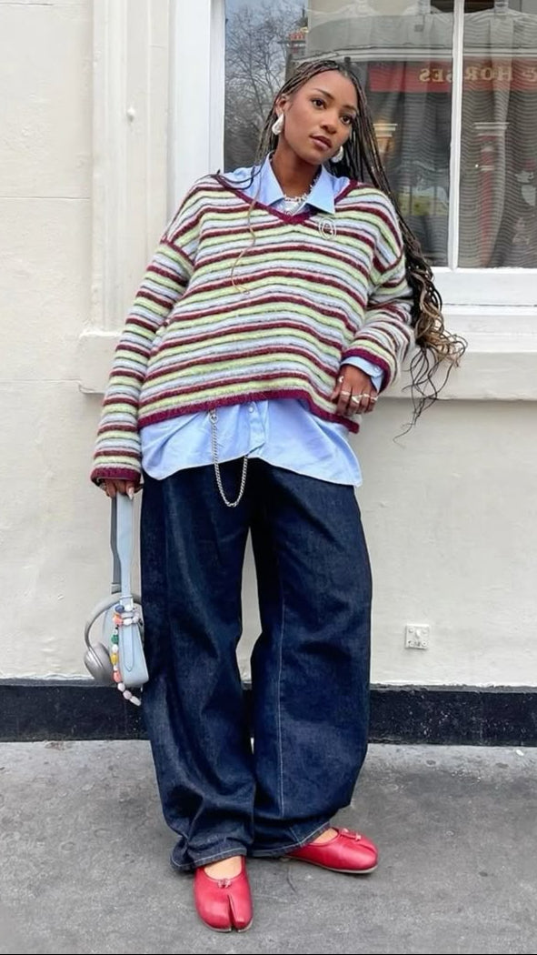 Woman in striped sweater wearing red split toe ballet flats