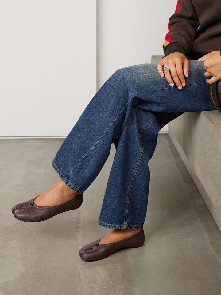 Brown split toe ballet flats paired with wide leg denim