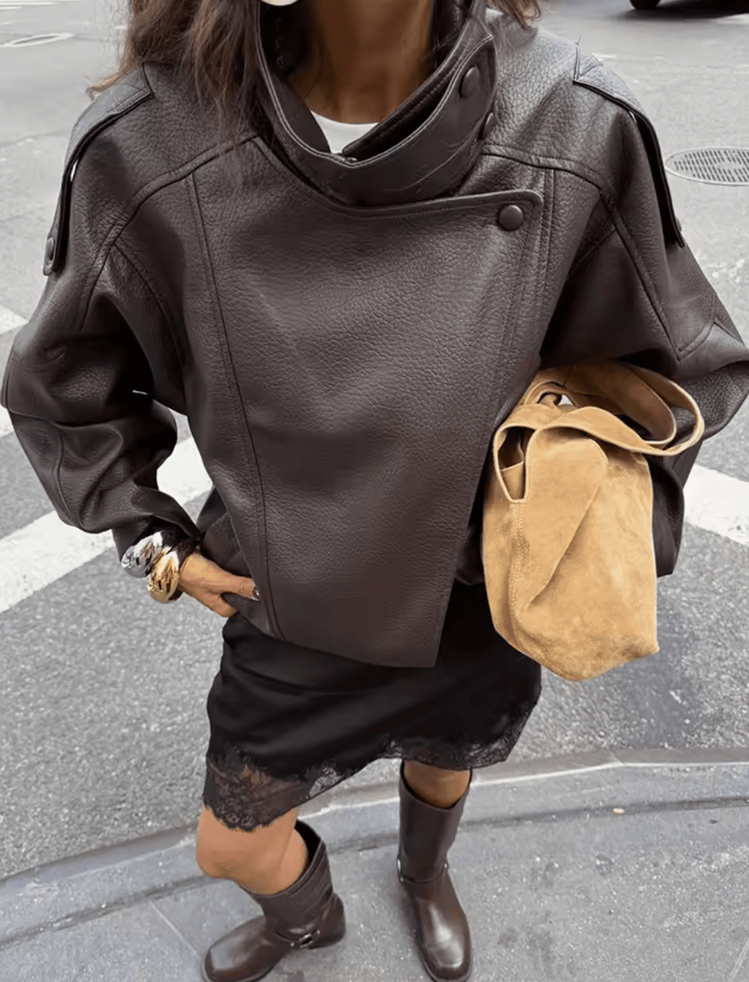 Model wearing brown leather jacket with funnel collar