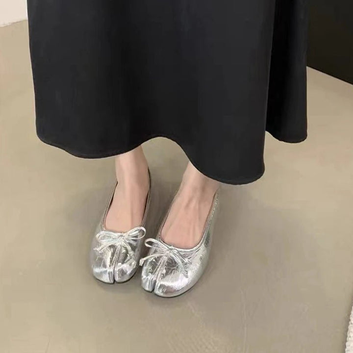 Silver tabi ballet flats worn with black skirt