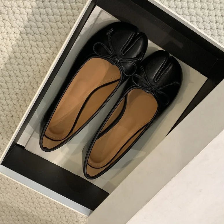 Black tabi ballet flats in shoe box