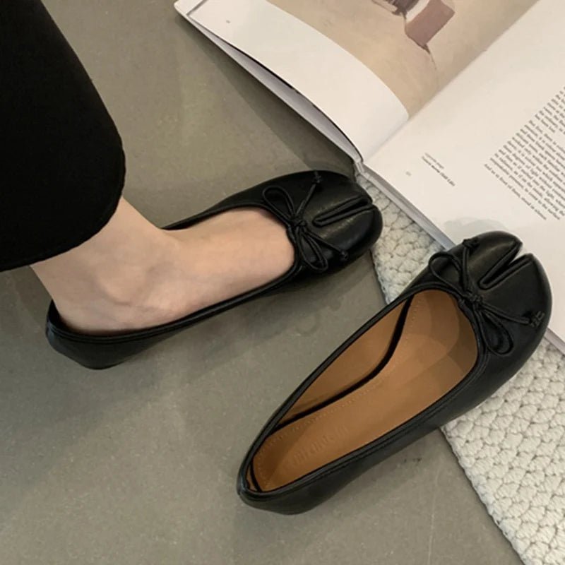 Black tabi ballet flats worn on foot with bow knot detail