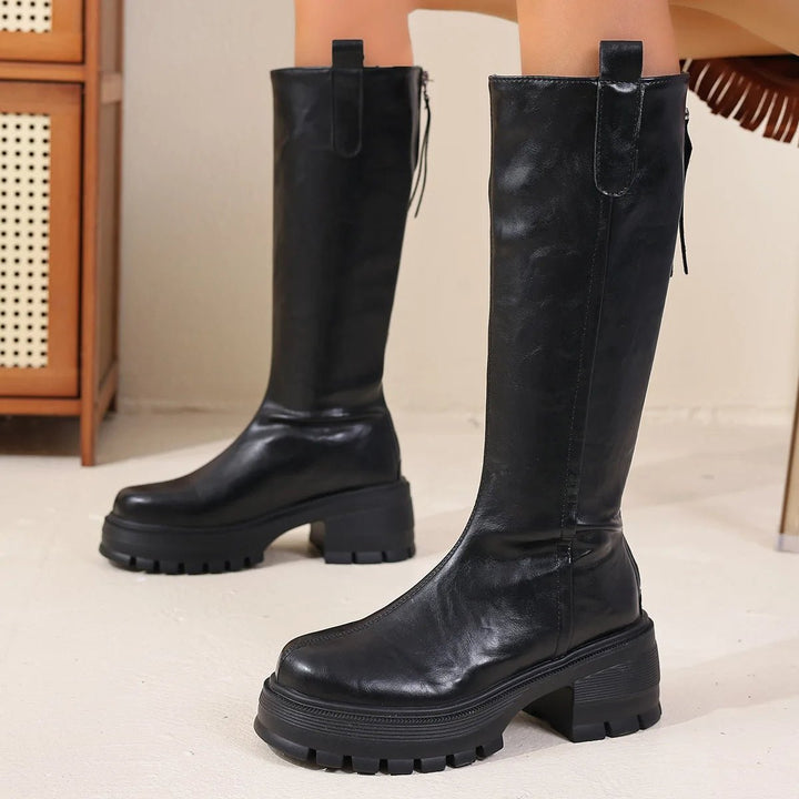 Black knee-high boots with side zip and pull tab, side view