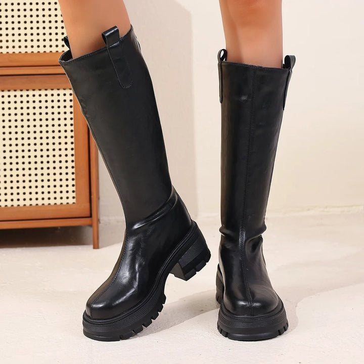 Black knee-high boots with chunky platform sole, back view